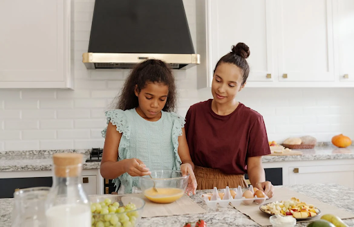 a mom and daughter cooking