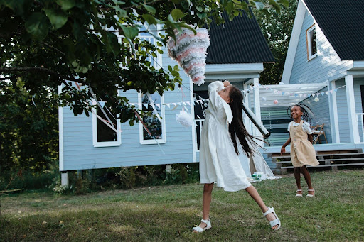 girl playing with pinata