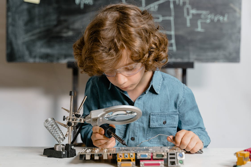 a child is using microscope