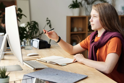 a girl looking at monitor