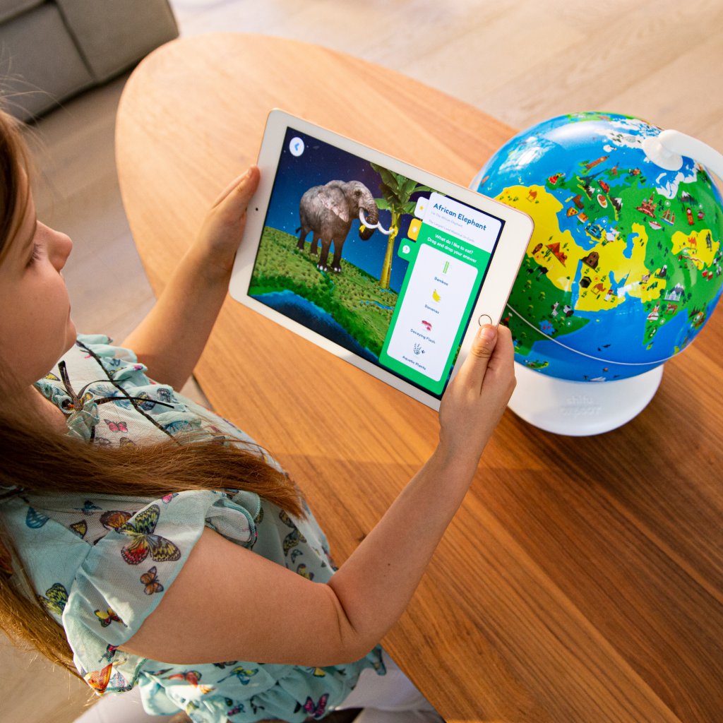 girl looking at elephant on iPad screen