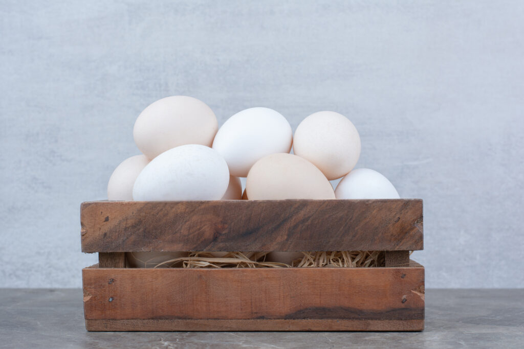 White eggs on brown tray