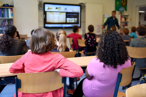 two girls seating in a classroom